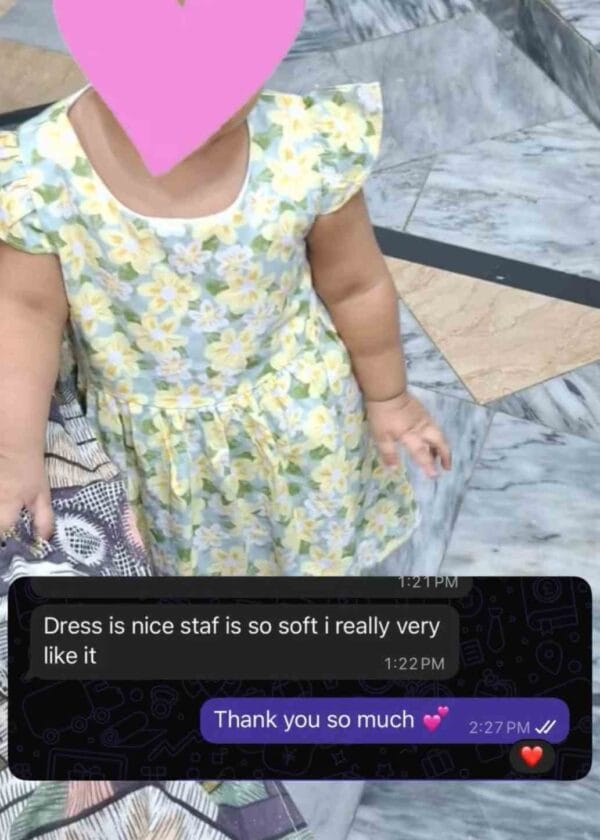 A mother's photo of her little girl in a yellow floral Kuku Kids frock with her message: the dress is nice, the stuff is so soft, I really like it