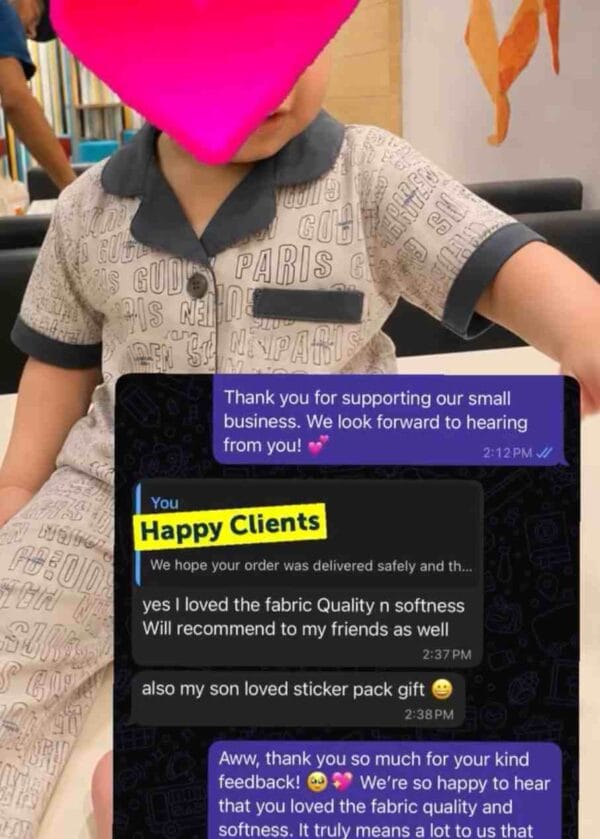Photo of a child in Paris print nightwear with a message: I loved the fabric quality and softness, will recommend to my friends, my son loved the sticker pack gift